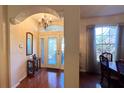 Inviting foyer with chandelier, decorative front door and sidelights, and hardwood floors at 2158 Fentress Ct, Spring Hill, FL 34609