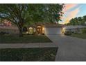 Charming single-Gathering home with a two-car garage and mature trees in a well-kept yard at 303 Rochester St, Spring Hill, FL 34609