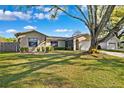 Inviting home with a well-kept lawn and mature landscaping and large tree at 31225 Stoney Brook Dr, Brooksville, FL 34602