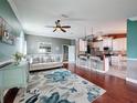Bright and open living room with tile and hardwood floors, featuring views to the kitchen at 4420 Devon Dr, New Port Richey, FL 34653