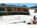 Well-maintained ranch-style home with lush landscaping and a concrete driveway at 4607 N Saint Vincent St, Tampa, FL 33614