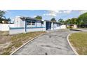 Charming single Gathering home, front view with driveway, featuring mature trees and inviting curb appeal at 6250 Vermont Ave, New Port Richey, FL 34653