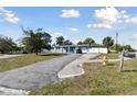 Charming single Gathering home, front view with driveway, featuring mature trees and inviting curb appeal at 6250 Vermont Ave, New Port Richey, FL 34653