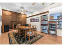 Cozy dining area featuring a fireplace, wood paneling, and classic furniture at 9545 Sunshine Blvd, New Port Richey, FL 34654