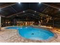 A stunning screened-in pool area with a turtle mosaic on the bottom, and elegant dolphin statues on the pool deck at 10136 Highcrest Ln, New Port Richey, FL 34654