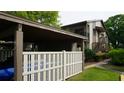 Exterior view of a well-maintained townhouse with private parking and a balcony, nestled in a lush community at 12820 Wedgewood Way # D, Hudson, FL 34667