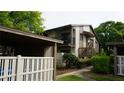 Exterior of a townhouse with a covered parking area, a private balcony, and a cozy patio area at 12820 Wedgewood Way # D, Hudson, FL 34667