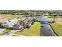 Aerial view showcasing the home's location on a waterfront property with a lush golf course view at 1809 Westerham Loop, Trinity, FL 34655