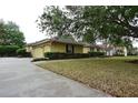 Well-maintained single-Gathering home with lush lawn, mature trees, and a two-car garage at 19109 Beckett Dr, Odessa, FL 33556