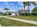 Beautiful single-story home with a well-kept lawn, mature trees, and an inviting entrance, located in a Gathering-friendly neighborhood at 22129 Yachtclub Ter, Land O Lakes, FL 34639