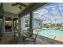 Inviting screened-in pool area with comfortable seating, perfect for outdoor relaxation and entertaining with lake views at 22129 Yachtclub Ter, Land O Lakes, FL 34639