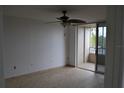 A bright bedroom with tile flooring, ceiling fan and access to a private balcony at 2333 Feather Sound Dr # A208, Clearwater, FL 33762