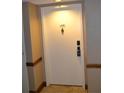 Condo front door with unit number, decorative knocker, and secure lock system at 2333 Feather Sound Dr # A208, Clearwater, FL 33762