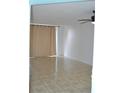 Bright living room with tile floors, ceiling fan, and neutral paint at 2333 Feather Sound Dr # A208, Clearwater, FL 33762