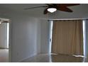 Living room features tile flooring, ceiling fan, and access to balcony at 2333 Feather Sound Dr # A208, Clearwater, FL 33762