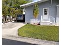 A well-manicured lawn and home's covered carport at 34135 Brown Bayou, Wesley Chapel, FL 33543
