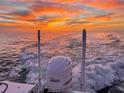 Stunning sunset view at sea, with the back of a boat and its motor as it speeds toward the horizon at 4058 Centavo Ct, Hernando Beach, FL 34607