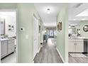 Hallway with stylish flooring and neutral walls, connecting the different living spaces in a harmonious manner at 4831 Wakefield Ct, New Port Richey, FL 34655
