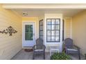Inviting front porch with seating, creating a relaxing space to enjoy the neighborhood's peaceful ambiance at 4831 Wakefield Ct, New Port Richey, FL 34655