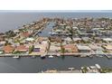 Stunning aerial view of waterfront houses on a canal, offering access to the bay at 5000 Southshore Dr, New Port Richey, FL 34652