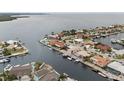 An aerial view shows waterfront homes with boat docks and easy access to bay, offering a coastal lifestyle at 5000 Southshore Dr, New Port Richey, FL 34652