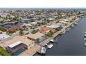 An aerial view of waterfront homes shows the canals, boat docks, and neighborhood layout at 5000 Southshore Dr, New Port Richey, FL 34652