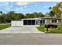 Charming single-story home with a screened porch and fenced parking area at 5005 Osprey Ln, New Port Richey, FL 34652