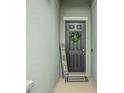 A welcoming front door adorned with a wreath and a personalized 'Home Sweet Home' sign at 582 8Th Nw St, Ruskin, FL 33570