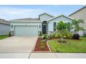Charming single-Gathering home featuring a two-car garage and well-manicured landscaping at 582 8Th Nw St, Ruskin, FL 33570