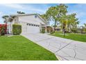 Lovely exterior with an attached garage and a wide patterned driveway at 7107 Pond View Ct, Spring Hill, FL 34606