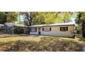 Charming single-story home featuring a metal roof and a well-maintained lawn at 807 S Castle Ct, Tampa, FL 33612