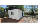 Exterior view of outbuilding featuring a white exterior and a window at 807 S Castle Ct, Tampa, FL 33612