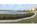 Tranquil waterfront view with lush landscaping and a walking path at 8251 Brent St # 918, Port Richey, FL 34668