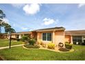 View of exterior elevation, showing manicured landscaping and neutral colors of a well-maintained home at 9321 Whitstone Ct, New Port Richey, FL 34655
