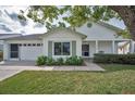 Charming single-story home featuring a well-maintained lawn, white brick, and a cozy front porch at 9336 Cape Charles Ave, New Port Richey, FL 34655