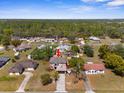 Expansive aerial view of a home with a large lot, mature trees, and convenient access to nearby amenities at 10399 Elgin Blvd, Spring Hill, FL 34608