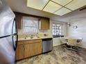 Functional eat-in kitchen with stainless steel appliances and natural light at 10635 Timber Ln, Port Richey, FL 34668