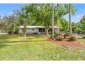 Well-maintained home with mature trees and lush greenery, providing a serene and private setting at 11326 Minnieola Dr, New Port Richey, FL 34654