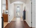 Inviting entryway with wood and tile flooring, arched doorway, and decorative glass door at 1250 Halapa Way, Trinity, FL 34655