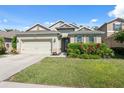 Beautiful single-Gathering home featuring a well-manicured lawn and a convenient two-car garage at 1250 Halapa Way, Trinity, FL 34655