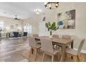 Elegant dining room with wood floors, neutral tones, and view to the living room, creating a welcoming atmosphere at 1709 Nodding Thistle Dr, New Port Richey, FL 34655