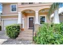 Inviting front porch with classic columns and brick steps leading to the entryway at 2506 W Ivy St, Tampa, FL 33607