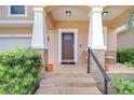 Charming front porch with brick steps, decorative pillars, and an inviting seating area at 2506 W Ivy St, Tampa, FL 33607