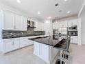 Modern kitchen features white cabinetry, granite countertops, and stainless steel appliances at 2630 Milford Berry Ln, Tampa, FL 33618
