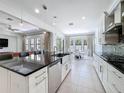 Modern kitchen boasts stainless steel appliances, sleek cabinetry, and an island with bar seating at 2630 Milford Berry Ln, Tampa, FL 33618