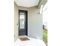 A closer view of the front door with a 'hello' doormat, offering a warm welcome to the home at 3465 Bumelia Ln, New Port Richey, FL 34655