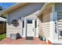 Close up of the front door with a decorative metal flourish above a small deck at 4725 3Rd S Ave, St Petersburg, FL 33711