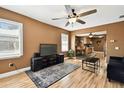 Inviting living room featuring wood floors and a ceiling fan, open to the kitchen and dining area at 4725 3Rd S Ave, St Petersburg, FL 33711