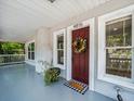 Welcoming front entrance with a decorative wreath, a 'Home' mat, and updated trim at 4816 N Highland Ave, Tampa, FL 33603