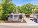 Charming single-story home with a covered front porch, landscaped yard, and a concrete driveway at 4816 N Highland Ave, Tampa, FL 33603
